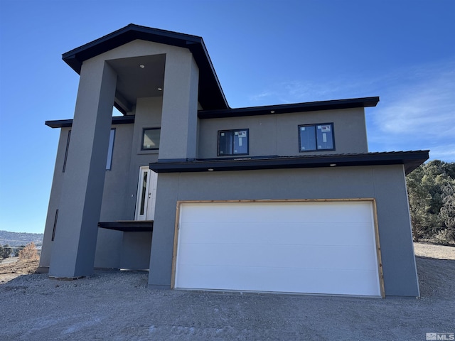 view of front of property featuring stucco siding and a garage