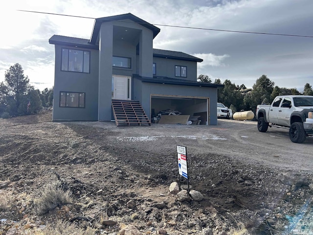 view of front of property with stucco siding and a garage