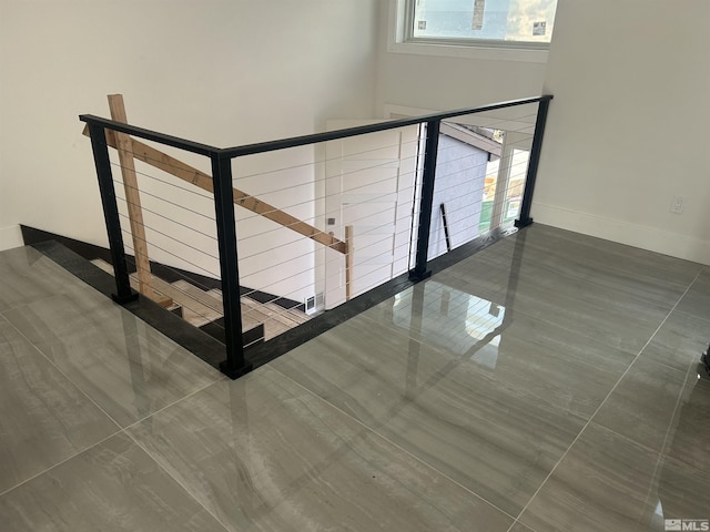 staircase with baseboards and a towering ceiling