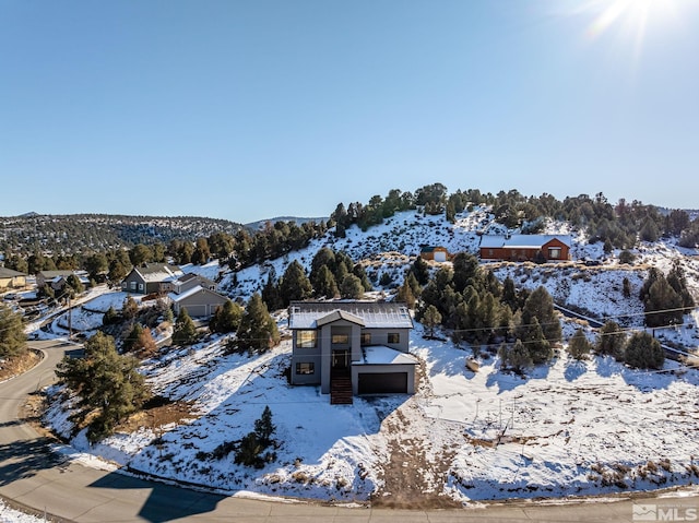 snowy aerial view with a mountain view