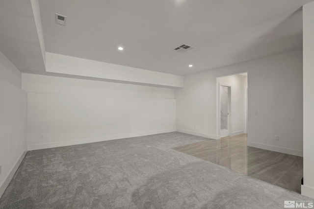 empty room featuring recessed lighting, visible vents, and baseboards