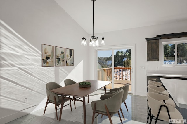 dining room featuring high vaulted ceiling