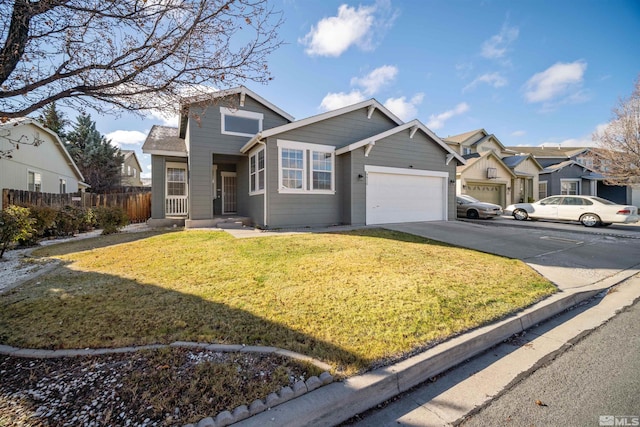 view of property featuring a garage and a front lawn