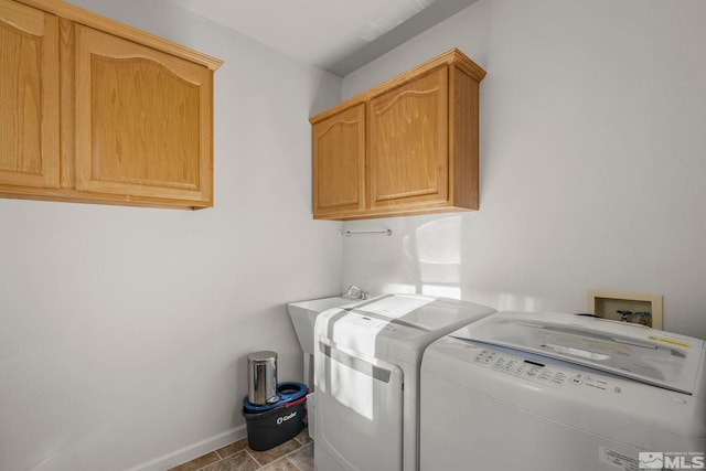 laundry area featuring cabinets and washing machine and clothes dryer