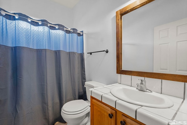 bathroom with backsplash, curtained shower, vanity, and toilet