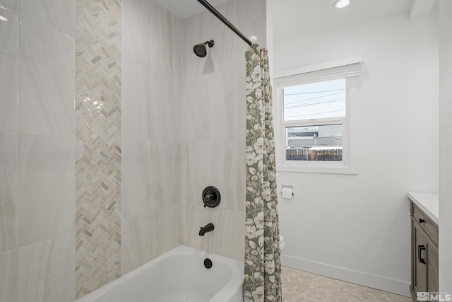 bathroom featuring vanity and shower / bathtub combination with curtain