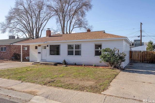 ranch-style home with a front lawn