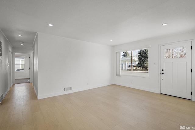 foyer entrance with plenty of natural light and light hardwood / wood-style floors