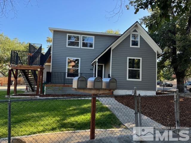 view of front of home featuring a front yard and a deck