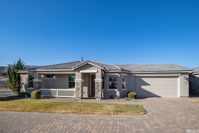 view of front of home with a porch and a garage