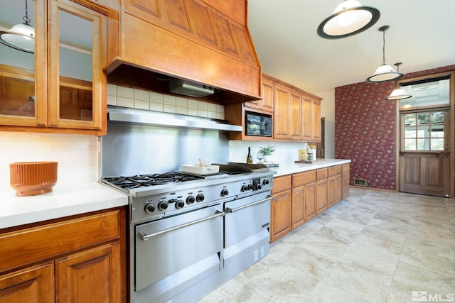 kitchen featuring black microwave, decorative light fixtures, decorative backsplash, high end stainless steel range, and custom range hood