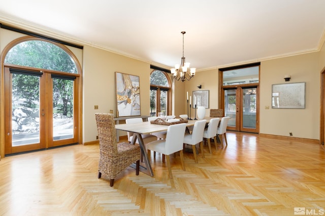 dining area with crown molding, french doors, light parquet floors, and a notable chandelier