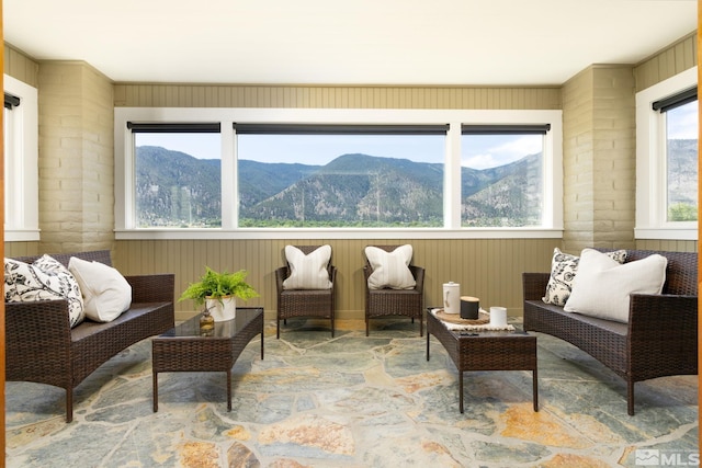 sunroom / solarium featuring a mountain view