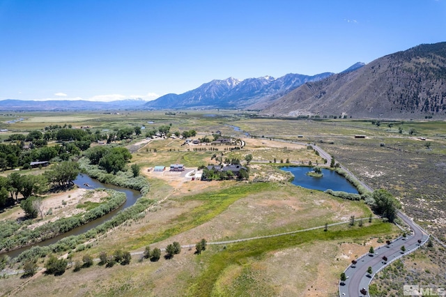 birds eye view of property with a water and mountain view and a rural view