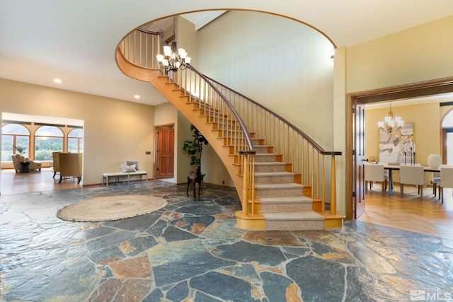 staircase with parquet flooring and a chandelier