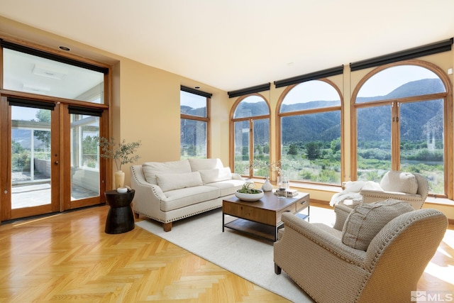 living room featuring a mountain view, french doors, and light parquet flooring