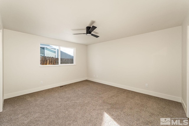 carpeted empty room featuring ceiling fan