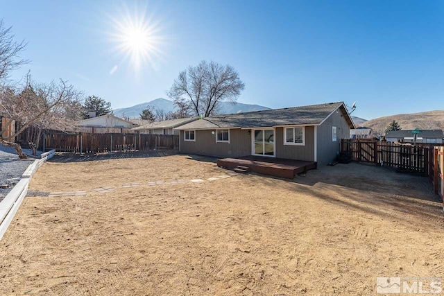 back of house featuring a deck with mountain view