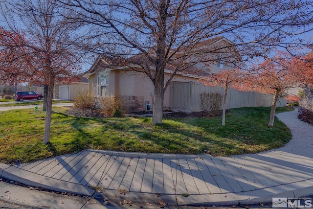 view of side of property with a yard