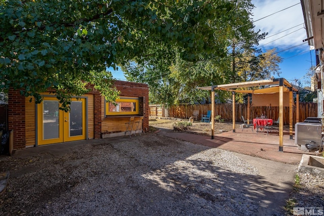 view of yard with a patio area and french doors