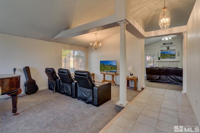 carpeted cinema featuring decorative columns, a chandelier, and vaulted ceiling