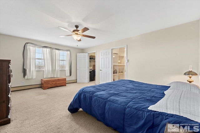 bedroom featuring ensuite bath, ceiling fan, carpet floors, and a baseboard heating unit