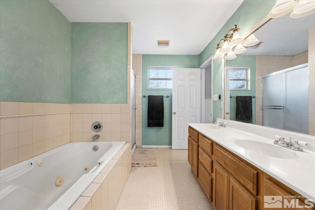 bathroom with tile patterned flooring, vanity, and shower with separate bathtub