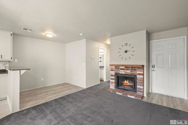 unfurnished living room featuring a fireplace and light hardwood / wood-style floors