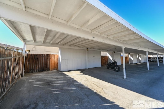 view of parking / parking lot featuring a carport