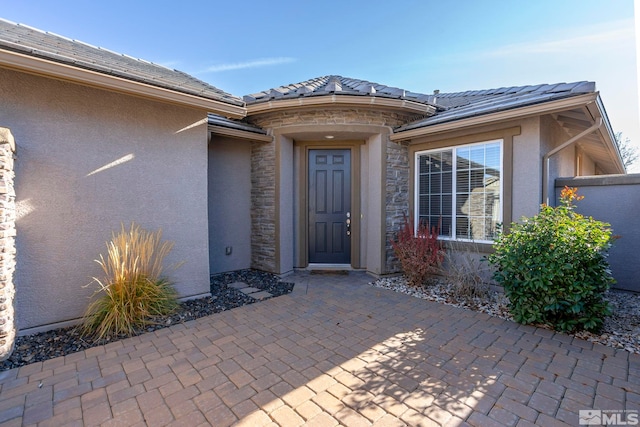 property entrance featuring a patio