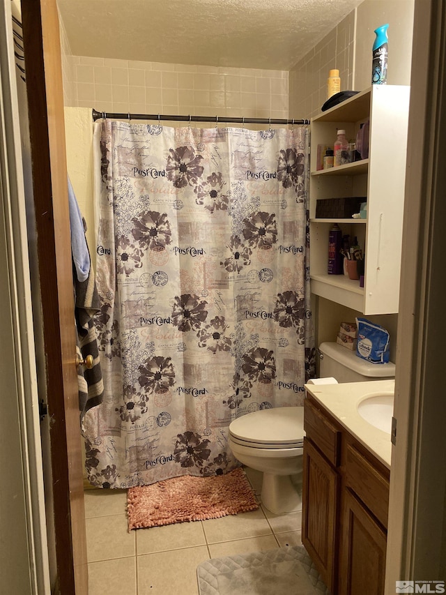 bathroom featuring vanity, tile patterned floors, toilet, a textured ceiling, and curtained shower