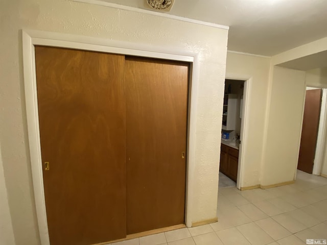 hallway with light tile patterned floors