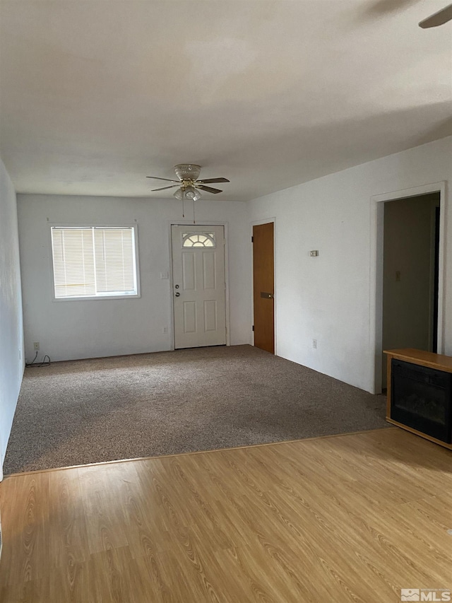 unfurnished living room with light hardwood / wood-style floors and ceiling fan