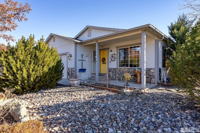 ranch-style home featuring a garage and covered porch