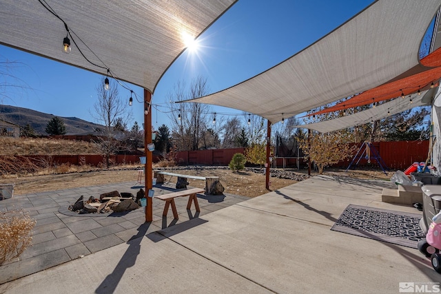 view of patio featuring a mountain view and an outdoor fire pit