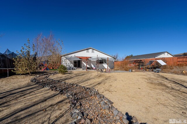 back of house featuring a trampoline