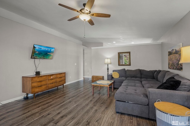 living room featuring ceiling fan and dark hardwood / wood-style floors