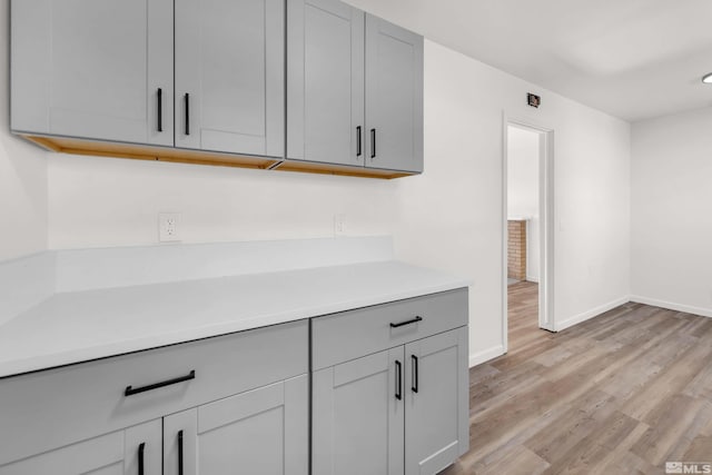 kitchen featuring gray cabinets and light hardwood / wood-style floors