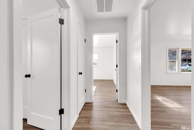 hallway with light hardwood / wood-style flooring