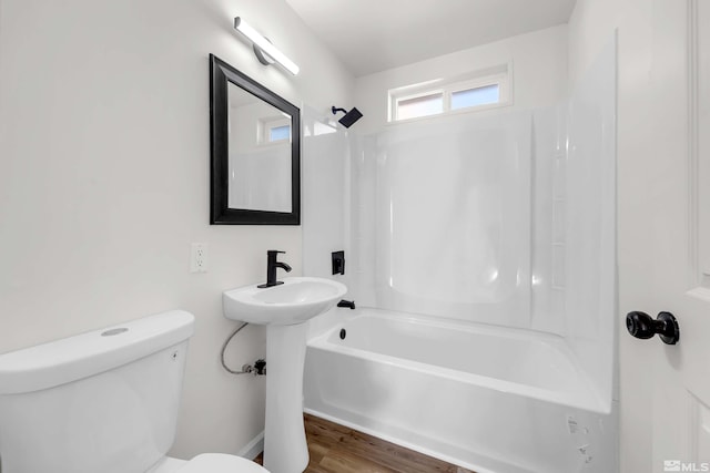 full bathroom featuring wood-type flooring, toilet, shower / washtub combination, and sink