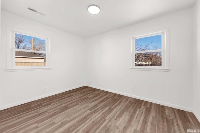 unfurnished room with wood-type flooring