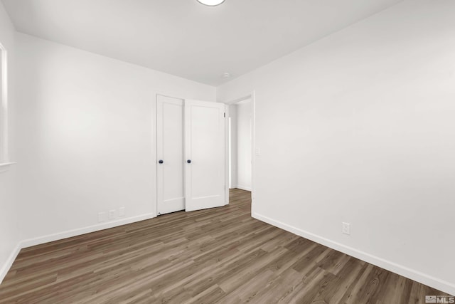 unfurnished room featuring dark hardwood / wood-style flooring