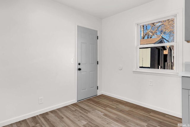 unfurnished room with light wood-type flooring