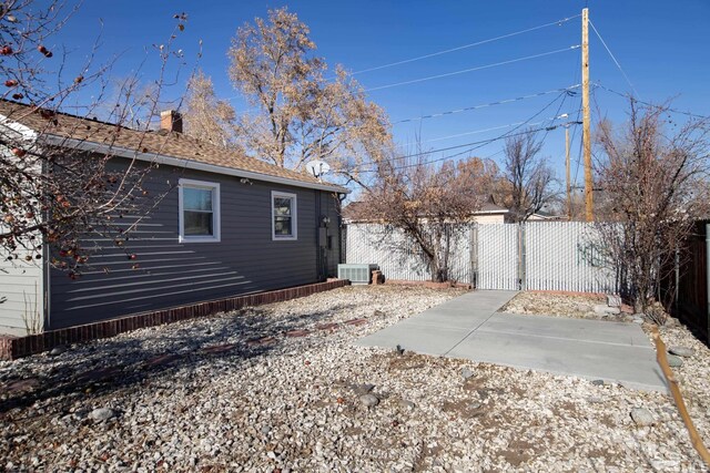 view of side of home featuring central air condition unit and a patio