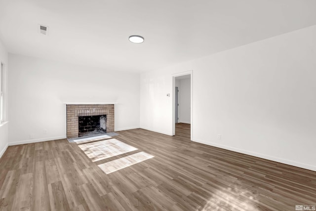 unfurnished living room with a fireplace and dark hardwood / wood-style flooring