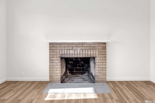 interior details featuring a fireplace and hardwood / wood-style flooring