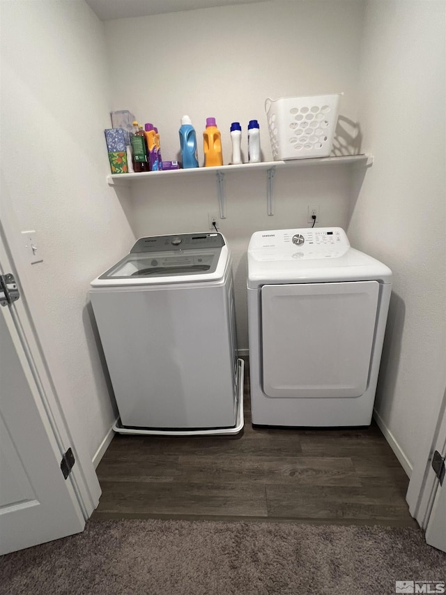 laundry area featuring washer and dryer and dark hardwood / wood-style floors