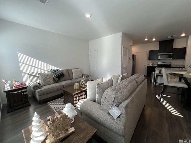 living room with dark hardwood / wood-style floors