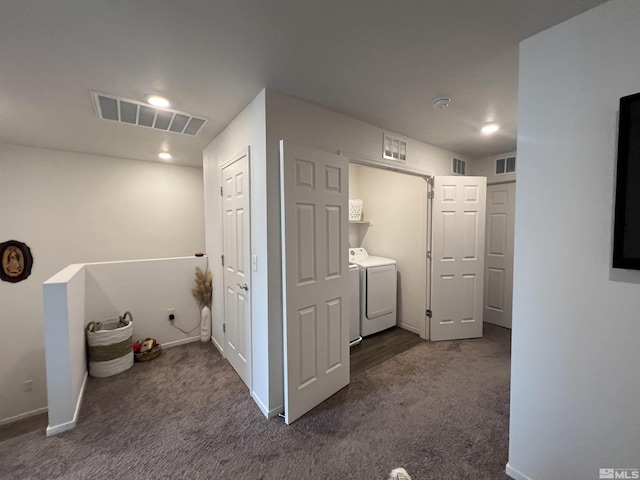 laundry area with dark colored carpet and washer and clothes dryer