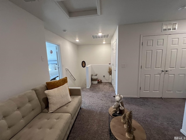 living room with dark colored carpet